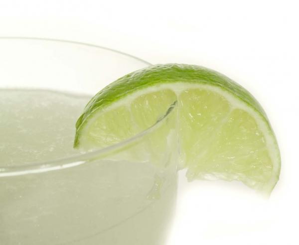 closeup of the top of a margarita with a wedge of lime