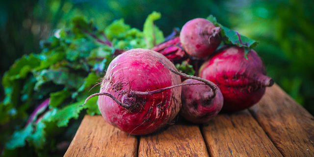 closeup of beets on a brown, wooden table