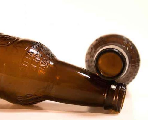two brown beer bottles on their side