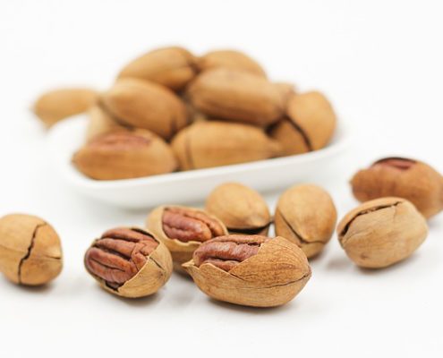 How the Manganese In Food Can Benefit Your Sex Drive 5 white bowl with nuts and several laying in front - a good source of manganese
