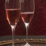 Cupid's Cocktail: A Valentine's Day Drink Recipe 2 Cupid's Kiss Champagne Cocktail recipe in two flutes on a mirrored tray