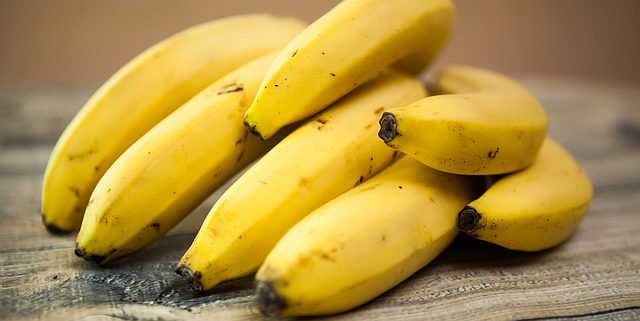 a bunch of bananas on a wooden table