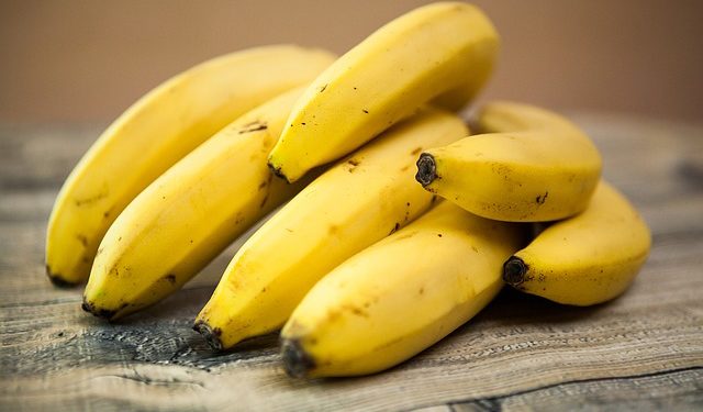 a bunch of bananas on a wooden table