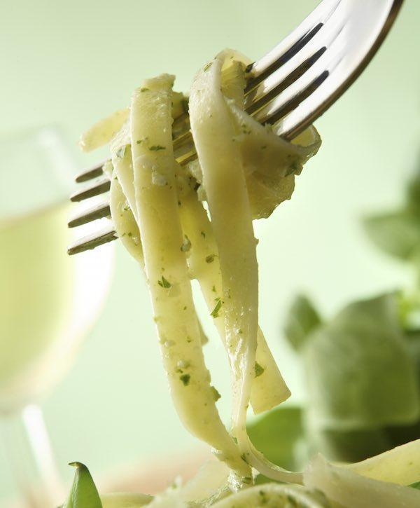 closeup of carrot top pesto rolled on a fork