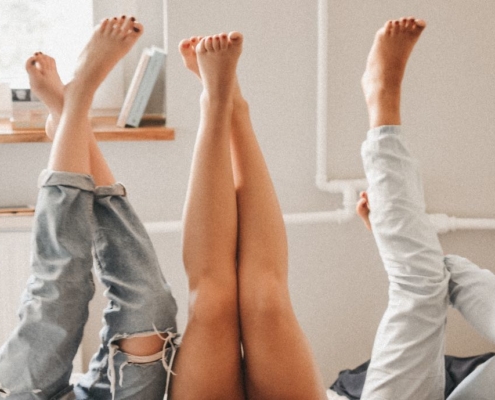 Three women's beautiful legs sticking up in the air