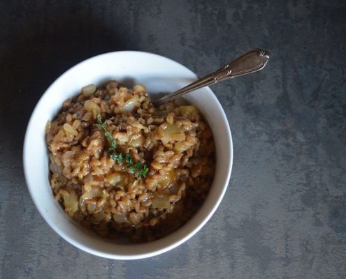 Overhead Look at Barley Risotto with Apple and Parmesan in a white bowl