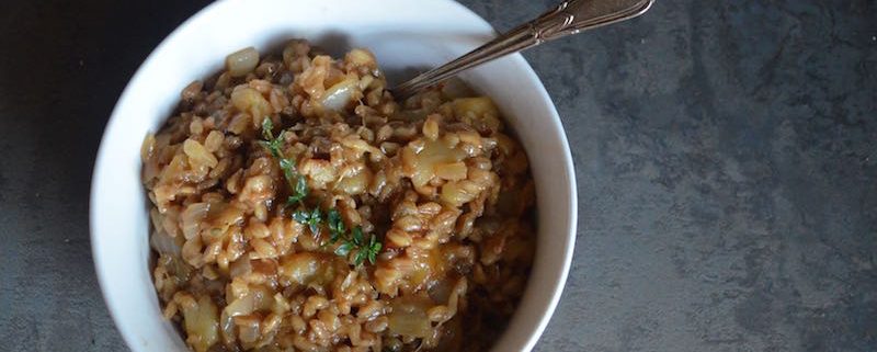 Overhead Look at Barley Risotto with Apple and Parmesan in a white bowl