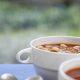 WhiteVegetarian White Bean Chili with Chocolate in a white bowl on a blue tablecloth