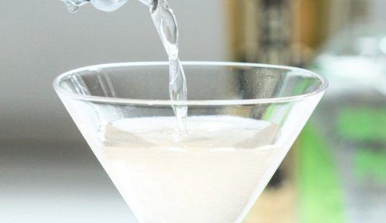 Yazi Mischief - a spicy vodka drink being poured from a shaker into a martini glass