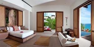 an example of one of the resort suites with white furniture and an ocean view