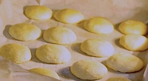 Peanut Butter and Jelly Cookies - for kids & adults 1 closeup of peanut butter and jelly cookies on a baking sheet covered with white parchment in the oven