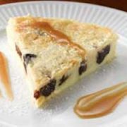 Fig Clafoutis Recipe with Homemade Caramel Sauce 2 Closeup of Black Mission Fig Clafoutis on white plate with two streaks of caramel sauce