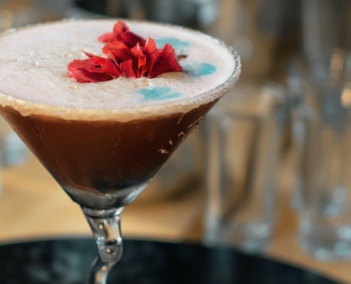 Lychee Chocolate Martini with edible flowers on top