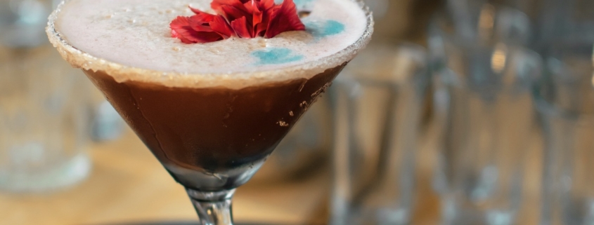 Lychee Chocolate Martini with edible flowers on top