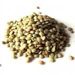 Closeup of green lentils on a white background