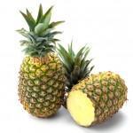 closeup of 2 pineapple, one standing upright, the other laying down with its top cut off
