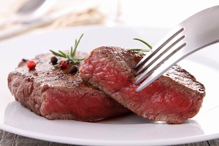 a fork in a lean piece of red meat to illustrate the concept, "choose healthy fats"