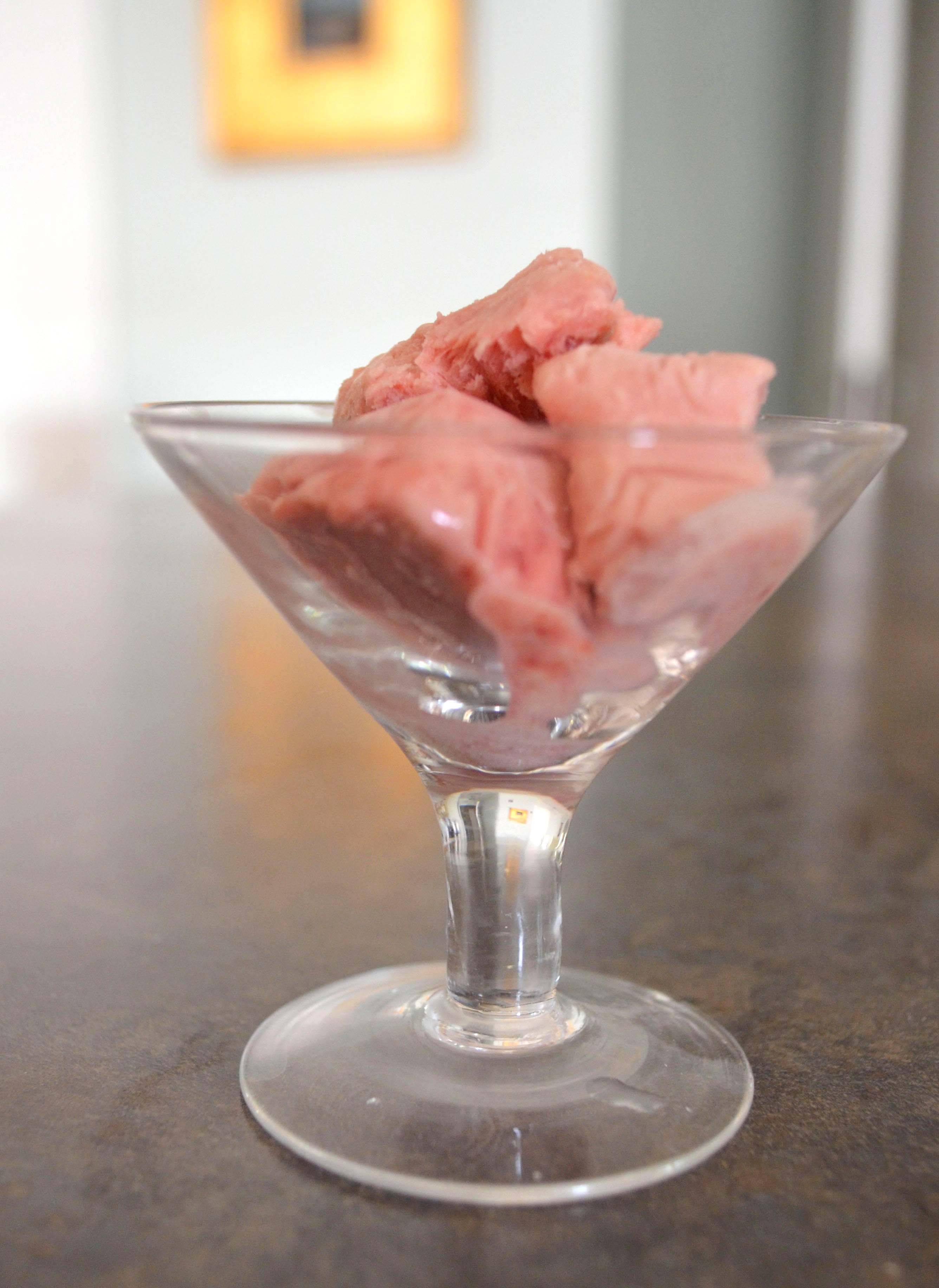 raspberry semifreddo in a martini glass on a gray background