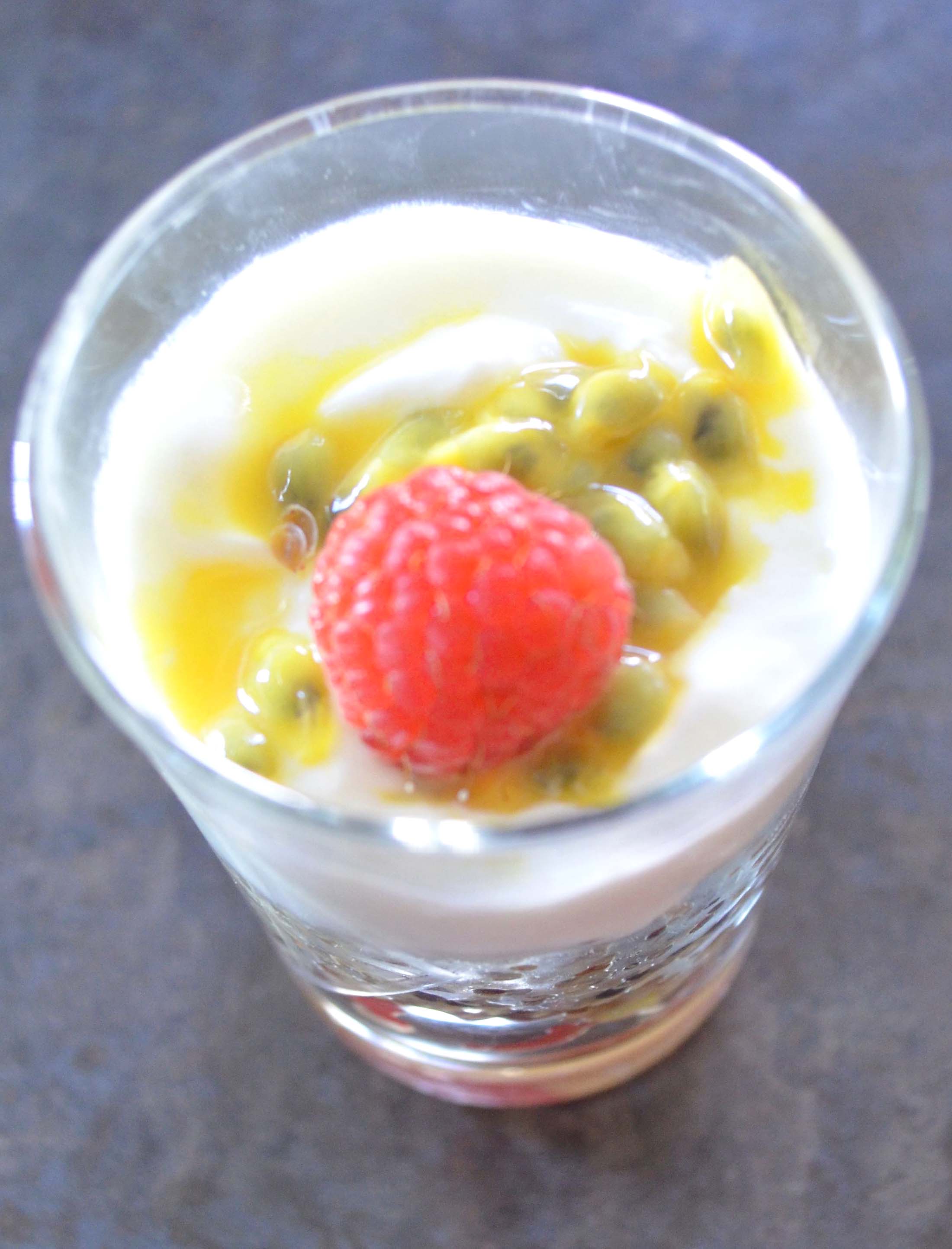 Closeup of Passion Fruit Quinoa Greek Yogurt Parfait with a raspberry on top