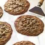 Closeup of Carl's Dark Chocolate Chunk Cookies on a baking sheet with a spatula