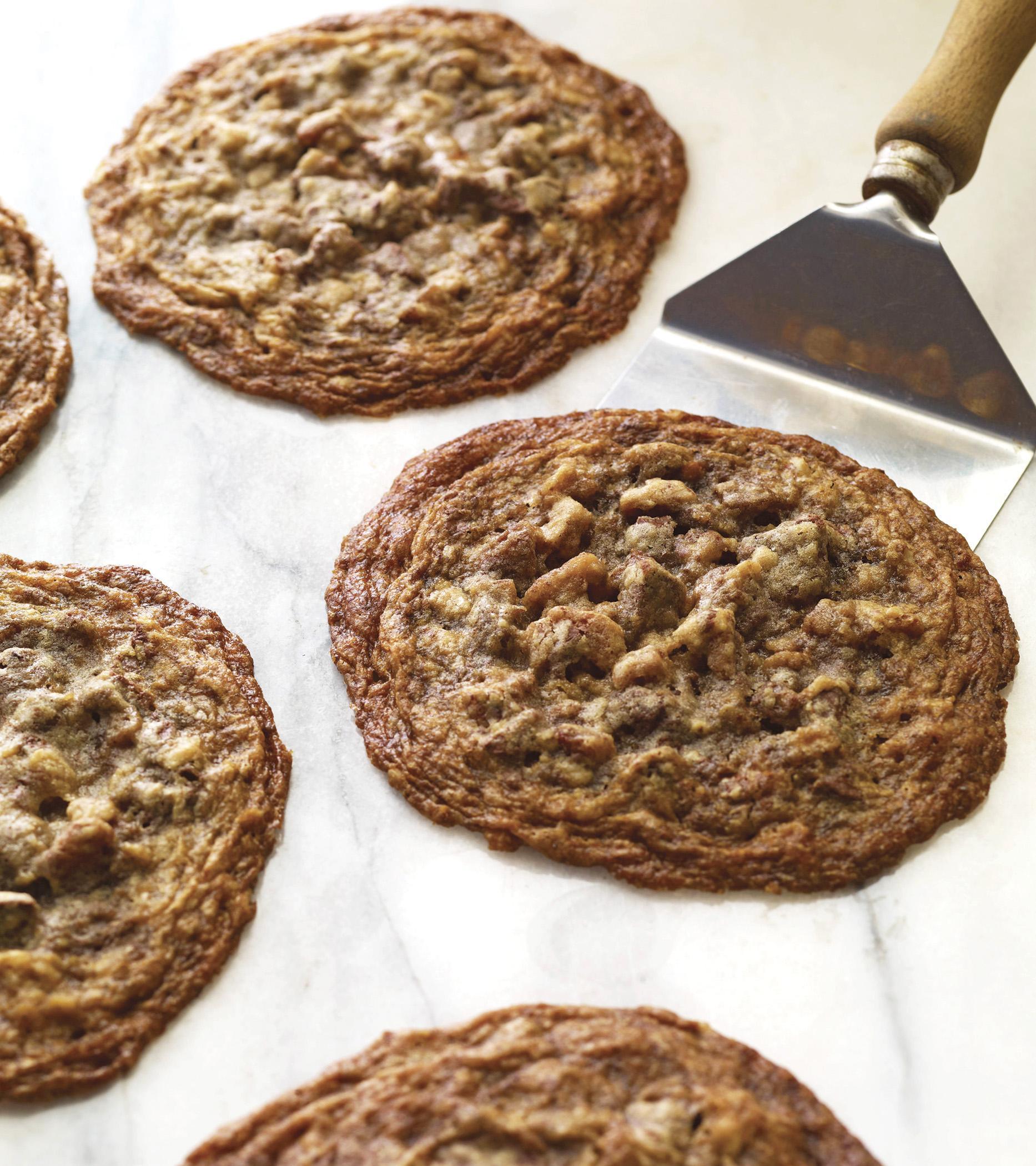 Closeup of Carl's Dark Chocolate Chunk Cookies on a baking sheet with a spatula