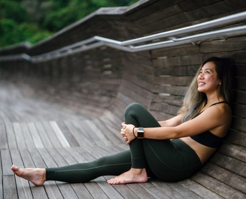 Healthy Woman Sitting on the ground, looking satisfied