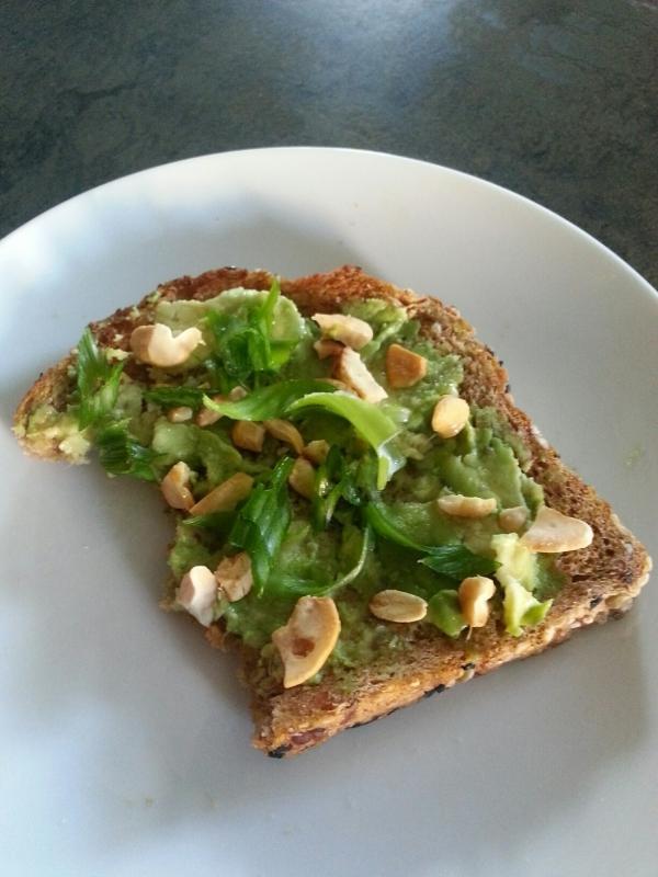 closeup of avocado toast with cashew and coconut