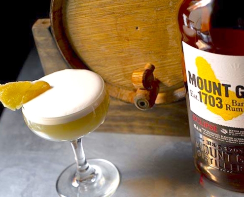 The Monaco - a Crème de Cacao Cocktail 5 creme de cacao cocktail with bottle of Mount Gay Eclipse and a bourbon barrel in the background