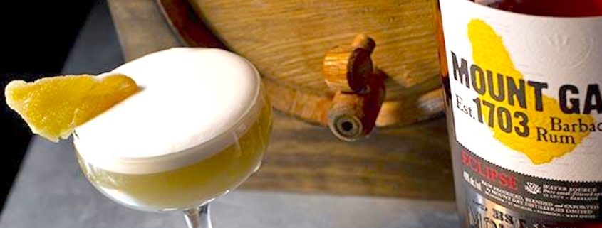 creme de cacao cocktail with bottle of Mount Gay Eclipse and a bourbon barrel in the background