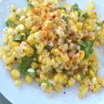 Grilled and Raw Corn Salad with Wild Arugula and Finger Lime 2 closeup of corn salad with finger lime and wild arugula on a white plate