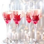 Wild Hibiscus flowers in syrup in glasses of champagne on a white background