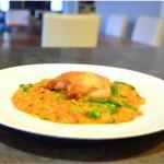Closeup of Spanish chicken with lentils on a white plate