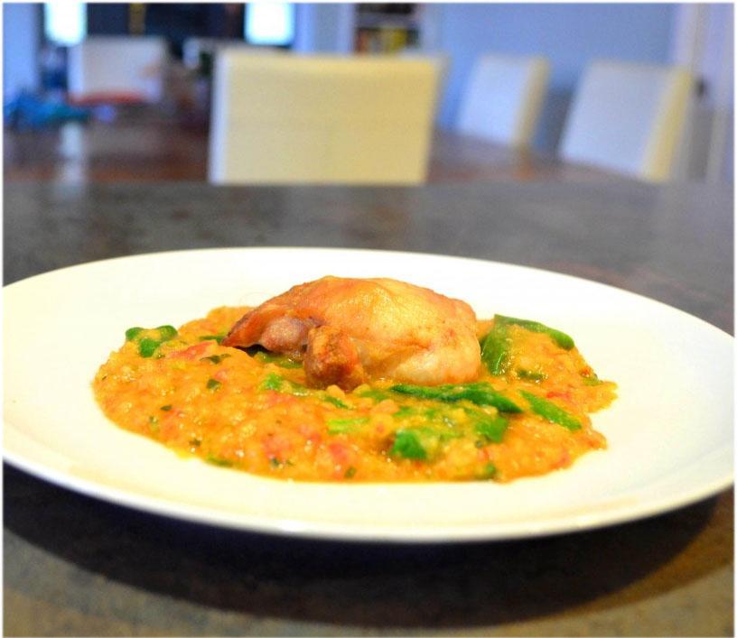 Closeup of Spanish chicken with lentils on a white plate