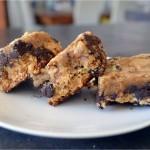 Three cookie bars stacked on a white plate