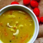 Closeup of butternut squash daal with cashews in a white bowl