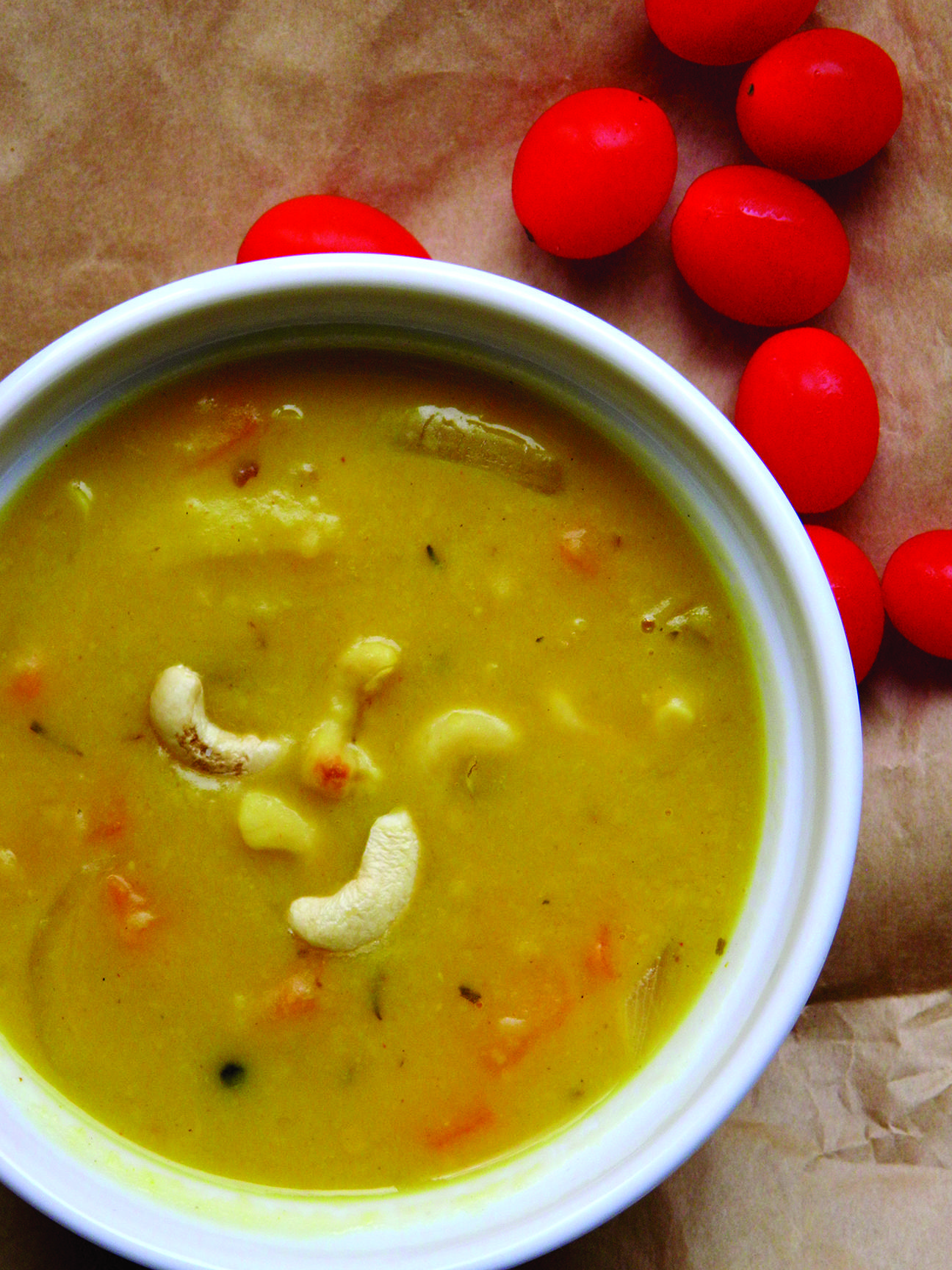 Closeup of butternut squash daal with cashews in a white bowl