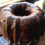 Chocolate Avocado Cake Recipe 2 Chocolate Avocado Cake on a clear plate next to a window