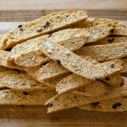 a stack of biscotti on a wooden cutting board