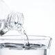 water being poured from a bottle to a glass