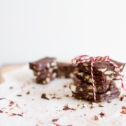 stack of chocolate bark on white parchment on a white table