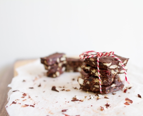 stack of chocolate bark on white parchment on a white table