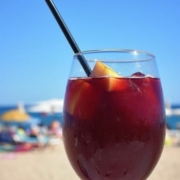 red wine sangria in a wine glass with a black straw