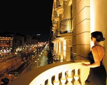 Woman in black dress standing on balcony of the Majestic