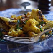 Curry Roasted Cauliflower on a blue tablecloth with a silver fork