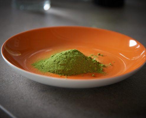 Orange bowl with pure moringa powder to illustrate moringa powder benefits