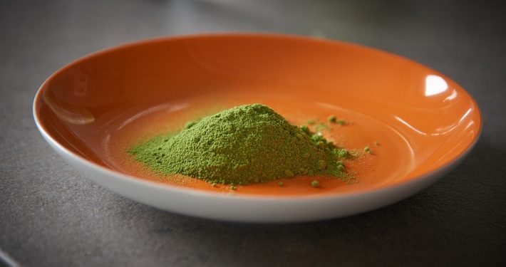 Orange bowl with pure moringa powder to illustrate moringa powder benefits