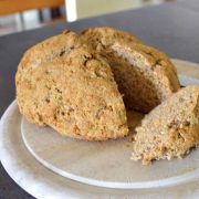 Traditional Irish Soda Bread on a round, wooden cutting board