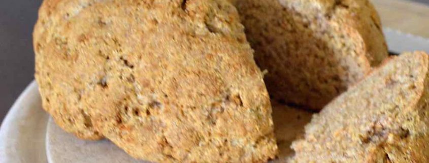 Traditional Irish Soda Bread on a round, wooden cutting board