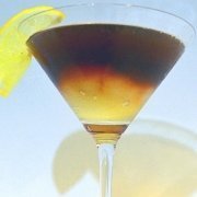 Closeup of the bourbon lemon cocktail with a lemon wedge for garnish