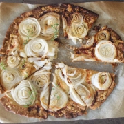 Overhead shot of easy cheese and onion tart on parchment paper